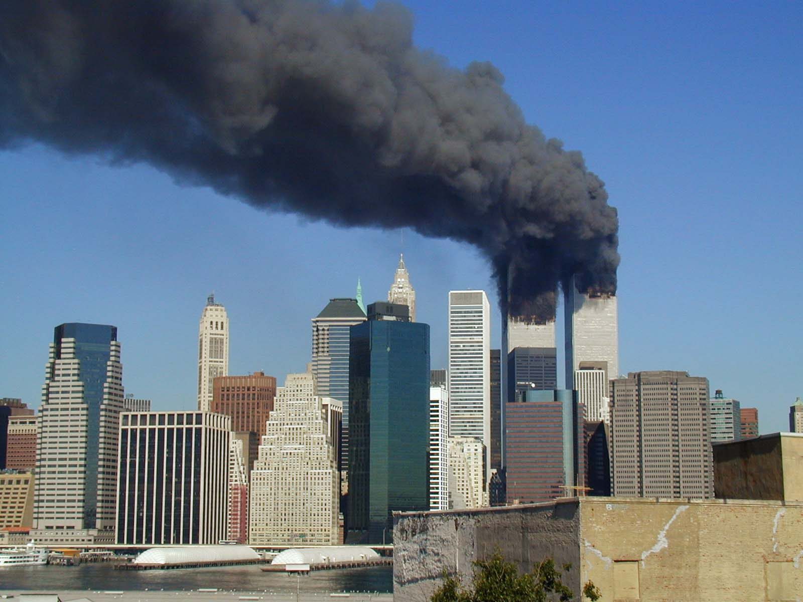 Plumes of smoke from WTC 1 and WTC 2 after each tower was struck by a Boeing 767.